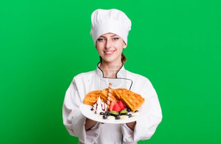 Téléchargez les photos : Caucasian pretty blonde woman. chef concept and waffles - en image libre de droit