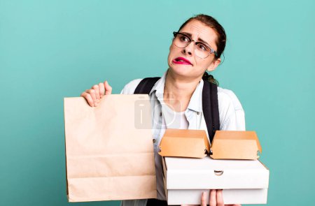 Photo for Young adult pretty woman with take away delivery fast food boxes - Royalty Free Image