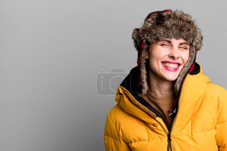 Photo for Young adult pretty woman wearing anorak and winter hat - Royalty Free Image