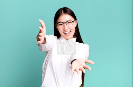 Photo for Young adult pretty asian expressive woman with a copy space to the side - Royalty Free Image