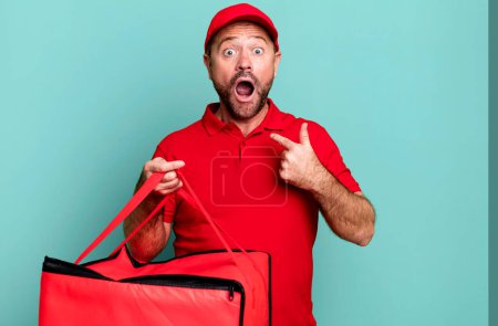 Photo for Middle age man feeling happy and pointing to self with an excited. pizza delivery man - Royalty Free Image