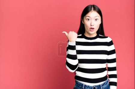 Photo for Pretty asian woman looking astonished in disbelief - Royalty Free Image