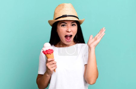 Téléchargez les photos : Hispanique jolie femme se sentant heureuse et étonnée de quelque chose d'incroyable. crème glacée et concept d'été - en image libre de droit