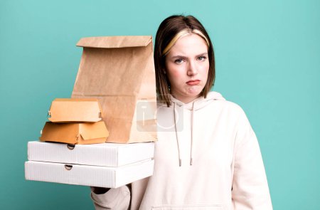 Photo for Young pretty woman feeling sad, upset or angry and looking to the side. take away fast food concept - Royalty Free Image