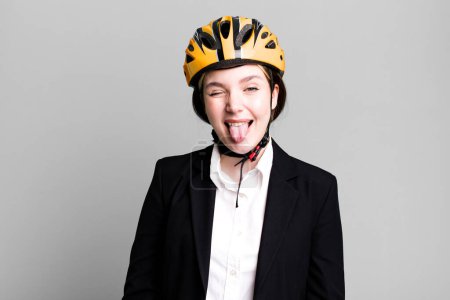 Photo for Young pretty woman with cheerful and rebellious attitude, joking and sticking tongue out. bike and businesswoman concept - Royalty Free Image