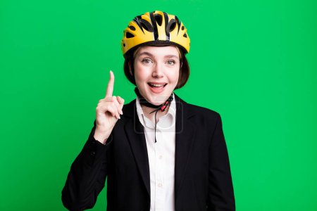 Photo for Young pretty woman feeling like a happy and excited genius after realizing an idea. bike and businesswoman concept - Royalty Free Image