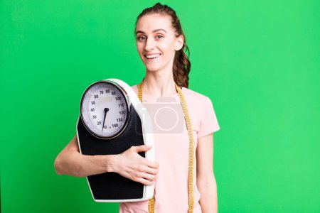 Photo for Young pretty woman looking happy and pleasantly surprised. fitness and diet concept - Royalty Free Image