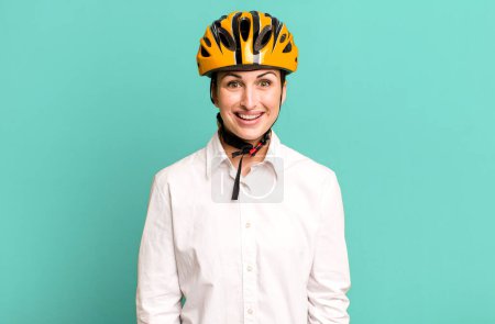 Photo for Young pretty woman looking happy and pleasantly surprised. business and bike concept - Royalty Free Image