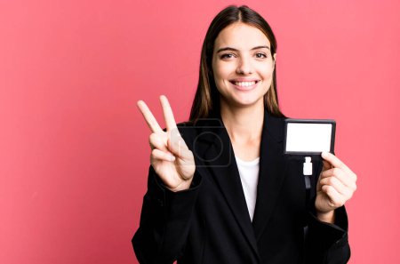 Téléchargez les photos : Young pretty woman with an id accreditation pass card - en image libre de droit