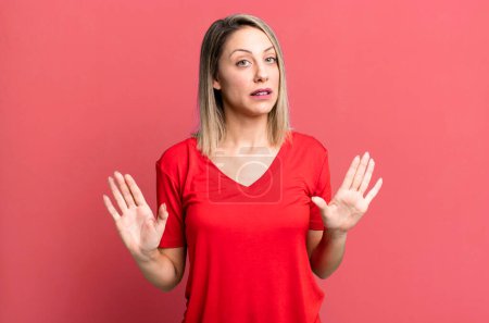 Photo for Blonde adult woman looking nervous, anxious and concerned, saying not my fault or I didnt do it - Royalty Free Image