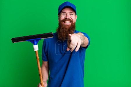 Photo for Young adult red hair bearded cool man. windows washer concept - Royalty Free Image
