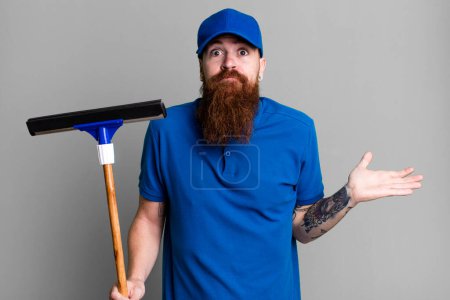 Photo for Young adult red hair bearded cool man. windows washer concept - Royalty Free Image