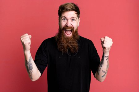 Photo for Long beard and red hair man feeling shocked,laughing and celebrating success - Royalty Free Image