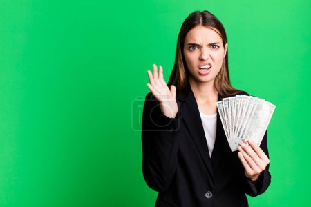 Photo for Young pretty woman screaming with hands up in the air. business and dolla banknotes concept - Royalty Free Image