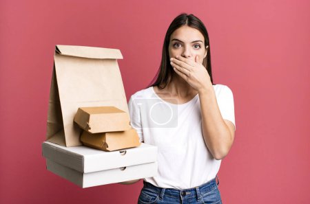 Photo for Young pretty woman covering mouth with hands with a shocked. delivery and take away concept - Royalty Free Image