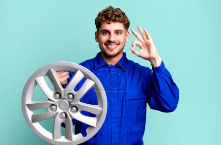 Photo for Young adult caucasian man feeling happy, showing approval with okay gesture. car repairman or mechanic concept - Royalty Free Image