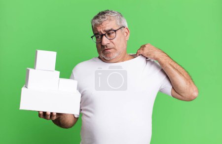 Photo for Middle age senior man feeling stressed, anxious, tired and frustrated. different packages blank boxes - Royalty Free Image