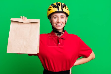 Téléchargez les photos : Pretty blonde deliverywoman with a paper bag - en image libre de droit