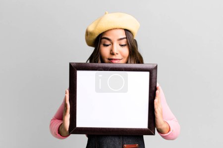 Photo for Hispanic pretty young adult woman with a blank copy space to present your concept - Royalty Free Image