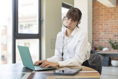 Photo for Young pretty woman feeling sad and whiney with an unhappy look and crying. telemarketer concept - Royalty Free Image