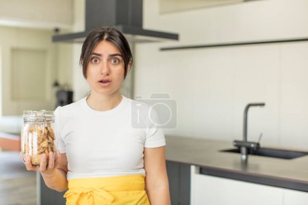 Photo for Young woman feeling extremely shocked and surprised. cookies concept - Royalty Free Image