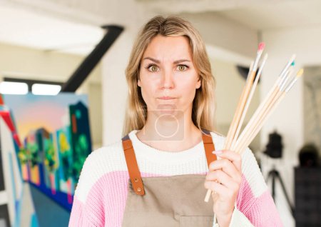Photo for Pretty young woman painting an artwork. artist concept. house interior design - Royalty Free Image