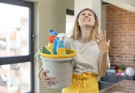 Photo for Young pretty woman screaming with hands up in the air. house keeper and clean product concept - Royalty Free Image
