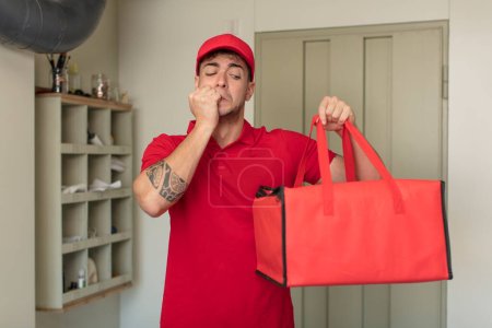 Photo for Young handsome man feeling scared, worried or angry and looking to the side. pizza delivery concept - Royalty Free Image