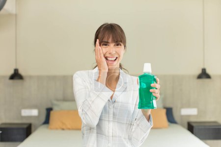 Photo for Young pretty woman feeling happy and astonished at something unbelievable. mouthwash concept - Royalty Free Image