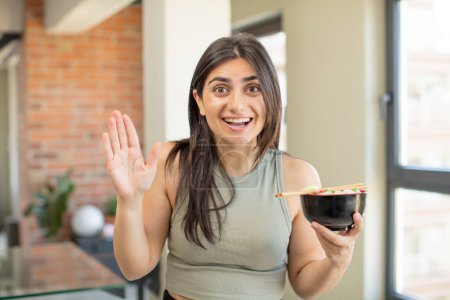 Photo for Young woman feeling happy and astonished at something unbelievable. ramen bowl - Royalty Free Image