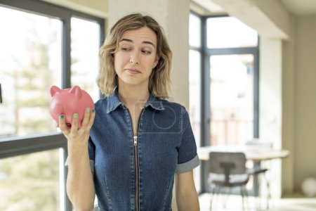 Photo for Pretty woman smiling and looking with a happy confident expression. piggy bank concept - Royalty Free Image