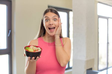 Photo for Young pretty woman feeling happy and astonished at something unbelievable. japanese ramen concept - Royalty Free Image