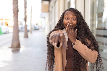 Photo for Afro pretty black woman laughing at you, pointing to camera and making fun of or mocking you - Royalty Free Image