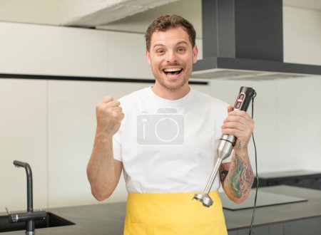 Photo for Feeling shocked,laughing and celebrating success. hand blender concept - Royalty Free Image