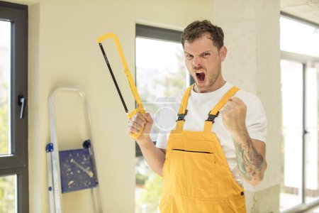 Photo for Looking angry, annoyed and frustrated. handyman saw concept - Royalty Free Image