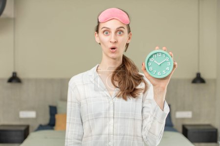 Photo for Feeling extremely shocked and surprised. alarm clock concept - Royalty Free Image