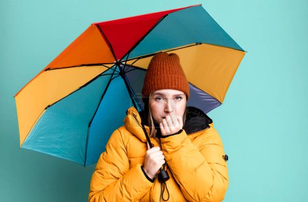 Photo for Young pretty woman wearing an anorak and a umbrella - Royalty Free Image