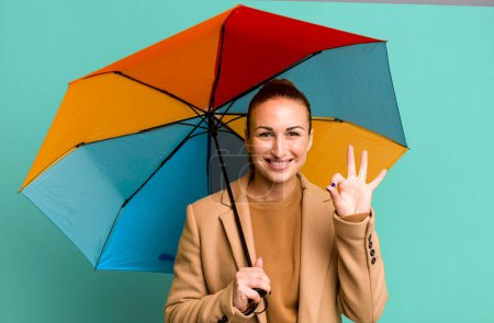 Téléchargez les photos : Young pretty woman holding an umbrella - en image libre de droit