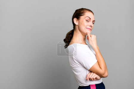 Foto de Young adult pretty woman wearing white shirt and a copy space - Imagen libre de derechos