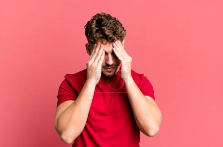 Photo for Young adult caucasian man looking stressed and frustrated, working under pressure with a headache and troubled with problems - Royalty Free Image