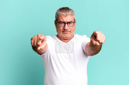 Photo for Middle age senior man pointing forward at camera with both fingers and angry expression, telling you to do your duty - Royalty Free Image