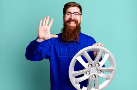 Photo for Long beard man smiling happily, waving hand, welcoming and greeting you. car mechanic concept - Royalty Free Image