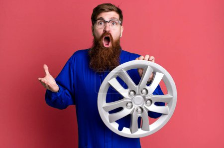 Photo for Long beard man amazed, shocked and astonished with an unbelievable surprise. car mechanic concept - Royalty Free Image