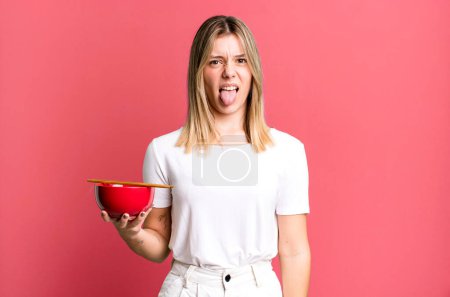 Photo for Young pretty woman feeling disgusted and irritated and tongue out. japanese ramen noodles concept - Royalty Free Image
