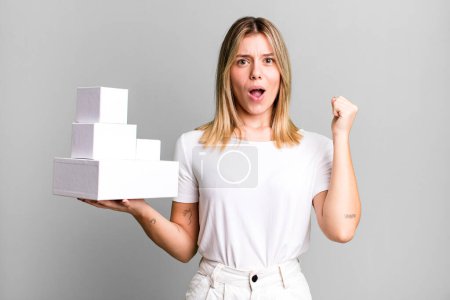 Photo for Young pretty woman shouting aggressively with an angry expression. blank white boxes concept - Royalty Free Image