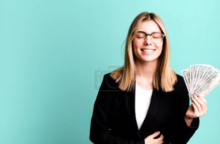 Photo for Young pretty woman laughing out loud at some hilarious joke. business and money concept - Royalty Free Image