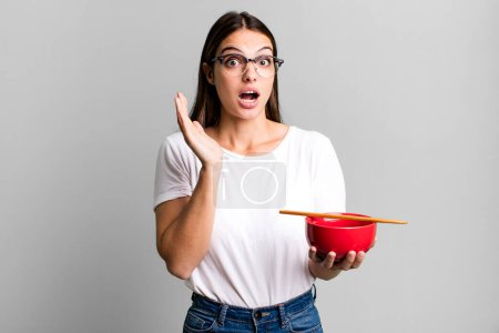 Photo for Young pretty woman feeling happy and astonished at something unbelievable. japanese ramen noodles concept - Royalty Free Image