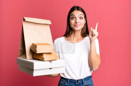 Photo for Young pretty woman feeling like a happy and excited genius after realizing an idea. delivery and take away concept - Royalty Free Image