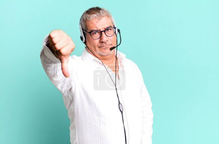 Photo for Middle age senior man feeling cross,showing thumbs down. telemarketer or client attention agent concept - Royalty Free Image