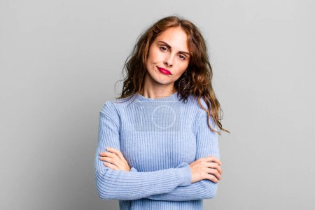 Photo for Young pretty woman feeling displeased and disappointed, looking serious, annoyed and angry with crossed arms - Royalty Free Image